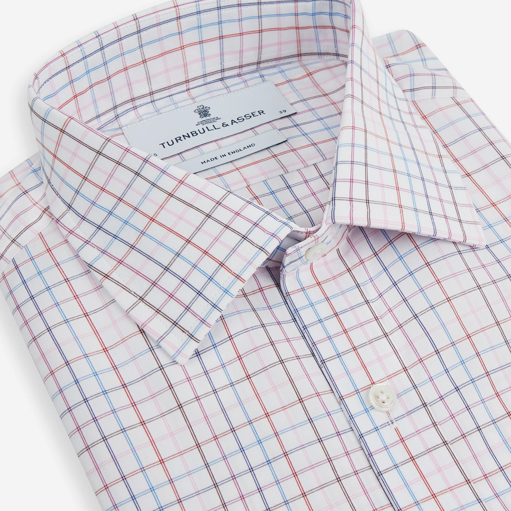 The Turnbull & Asser Pink Multi Double Grid Check Mayfair Shirt, made from organic cotton with a pointed collar and buttoned cuffs, features a light pink base with blue and red grid checks and is shown flat on a white background.