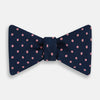 View 1 of product The Navy and Pink Spot Silk Bow Tie by Turnbull & Asser features evenly spaced pink polka dots on navy silk, shown against a plain white background.