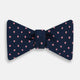 The Navy and Pink Spot Silk Bow Tie by Turnbull & Asser features evenly spaced pink polka dots on navy silk, shown against a plain white background.
