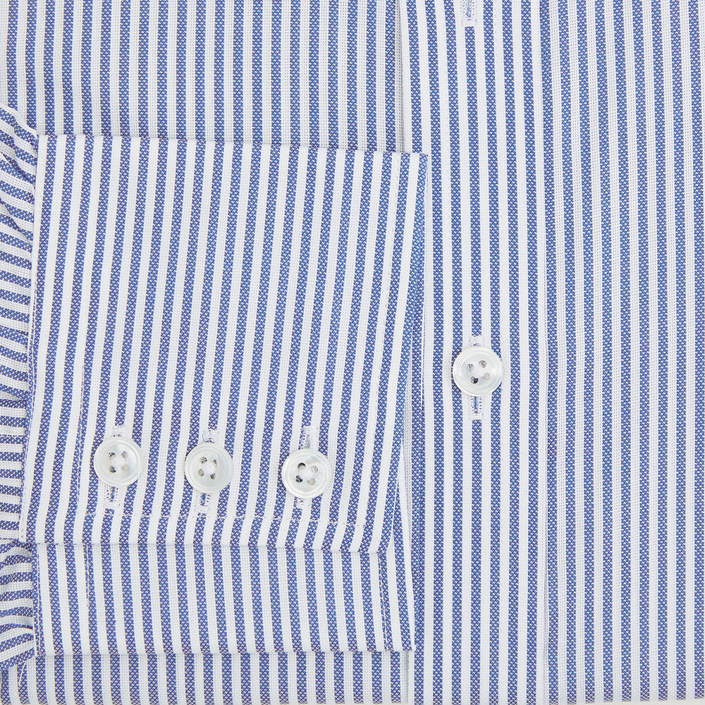 The Turnbull & Asser Navy Bengal Stripe Mayfair Shirt is a long-sleeved, collared formal shirt with blue and white stripes, white buttons, and buttoned cuffs—ideal for classic style enthusiasts. Displayed on a plain white background.