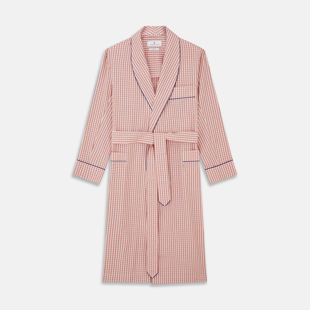 The Turnbull & Asser Orange Multi Check Cotton Arnold Gown features long sleeves, a shawl collar, wrap-around belt, and dark piping on the edges and pocket, displayed flat on a white background.