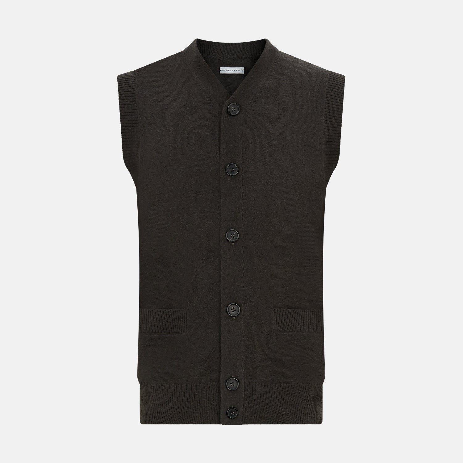 View 1 of product The Turnbull & Asser Dark Brown Cashmere Sleeveless Cardigan has a V-neck, button-up front, two front pockets, and ribbed trim on the armholes and hem, shown against a plain white background.