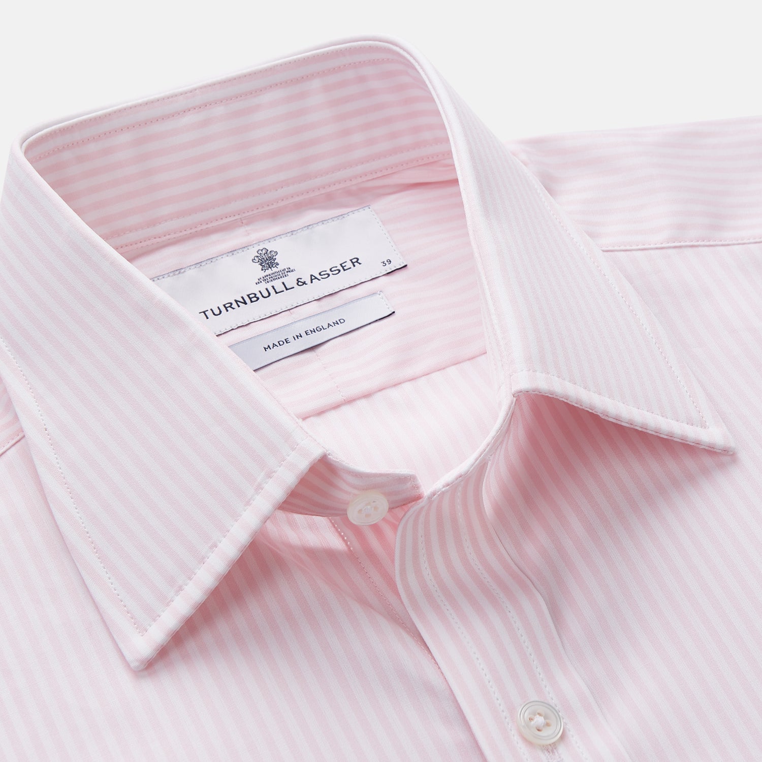 View 4 of product The Turnbull & Asser White and Pink Wide Stripe Mayfair Shirt features long sleeves, a collar, and bold vertical stripes, shown laid flat on a white background.