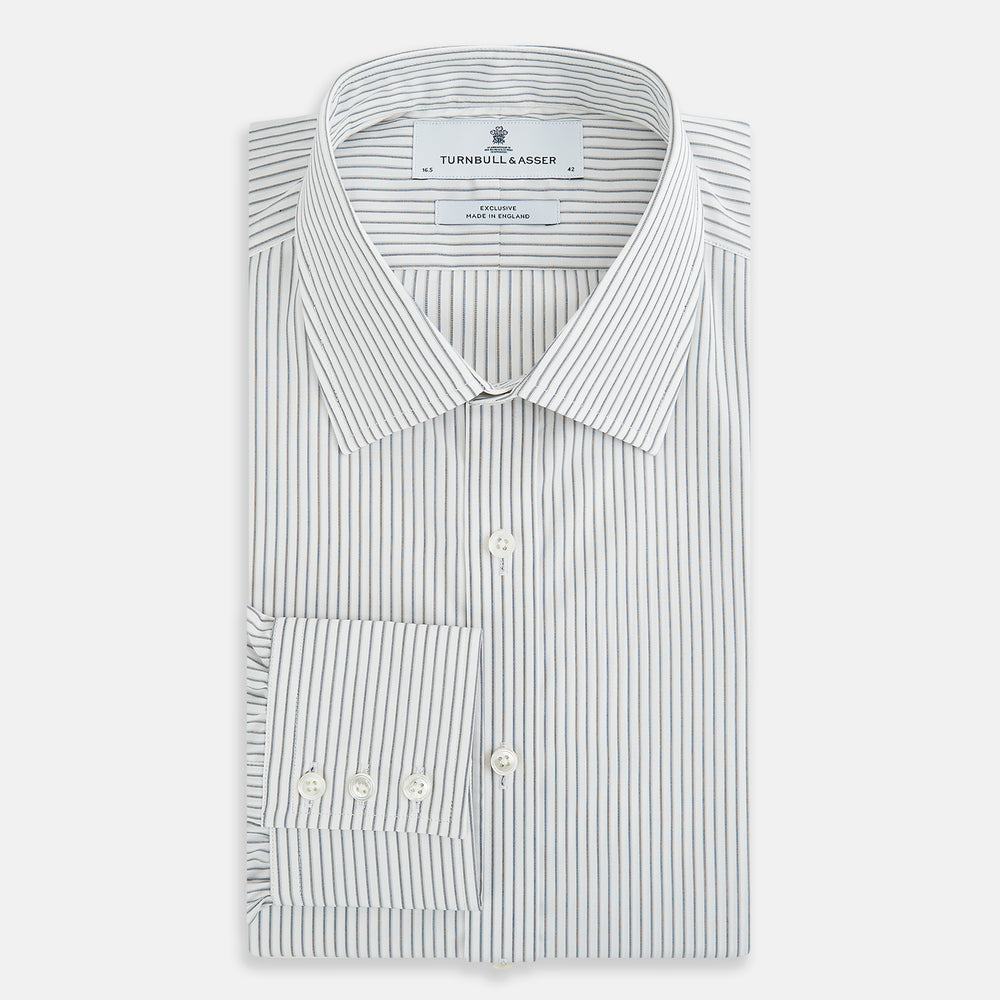 The Navy Music Stripe Mayfair Shirt by Turnbull & Asser features thin vertical blue and white stripes, a classic T&A collar, and long sleeves, shown on a plain white background.