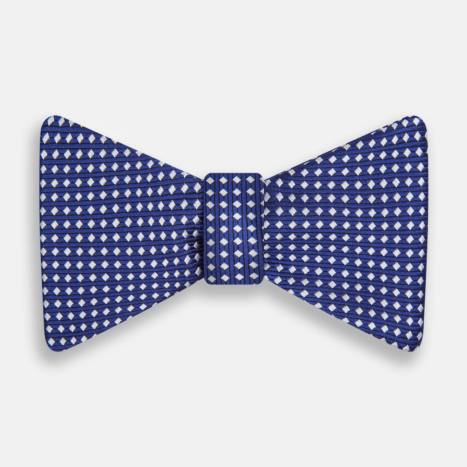 View 1 of product The Turnbull & Asser Blue and White Diamond Silk Bow Tie features a repeating pattern of small white diamonds and vertical ribbing, making it perfect for formalwear. Displayed on a white background.