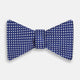 The Turnbull & Asser Blue and White Diamond Silk Bow Tie features a repeating pattern of small white diamonds and vertical ribbing, making it perfect for formalwear. Displayed on a white background.