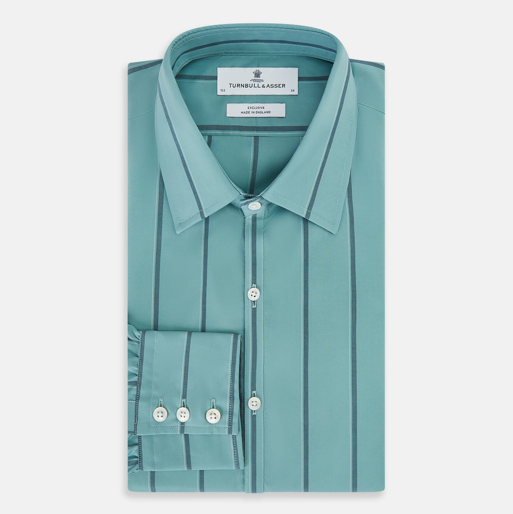 The Turnbull & Asser Sage Track Stripe Westminster Shirt features long sleeves, a tailored fit, a collar, and vertical dark blue stripes, with button closures down the front and at the cuffs, shown laid flat on a white background.