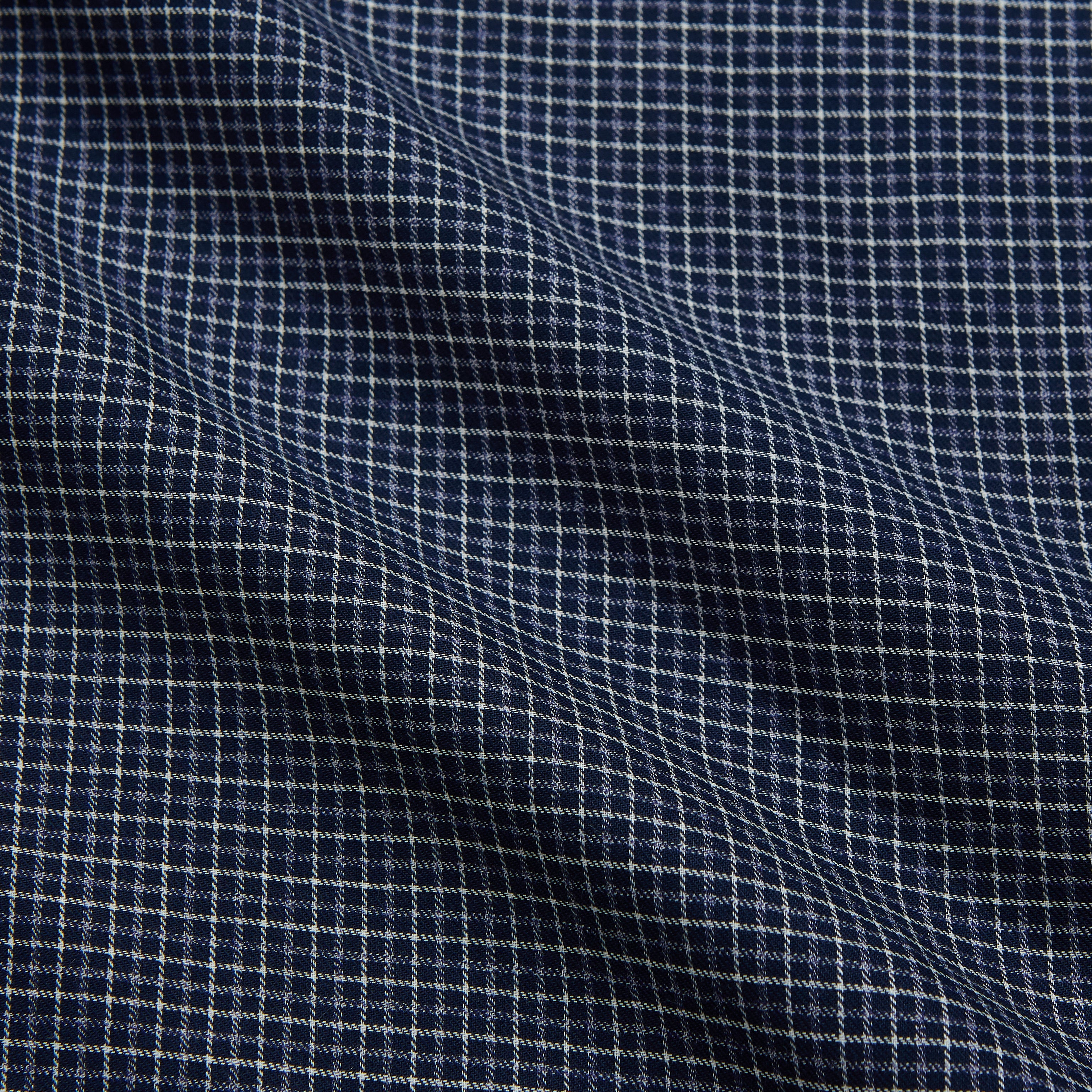 View 4 of product The Turnbull & Asser Navy Check Weekend Fit Flannel Shirt features a stand collar, button front, two chest pockets with flaps, and 1-button cuffs, crafted from soft Italian cotton and shown laid flat on a white background.