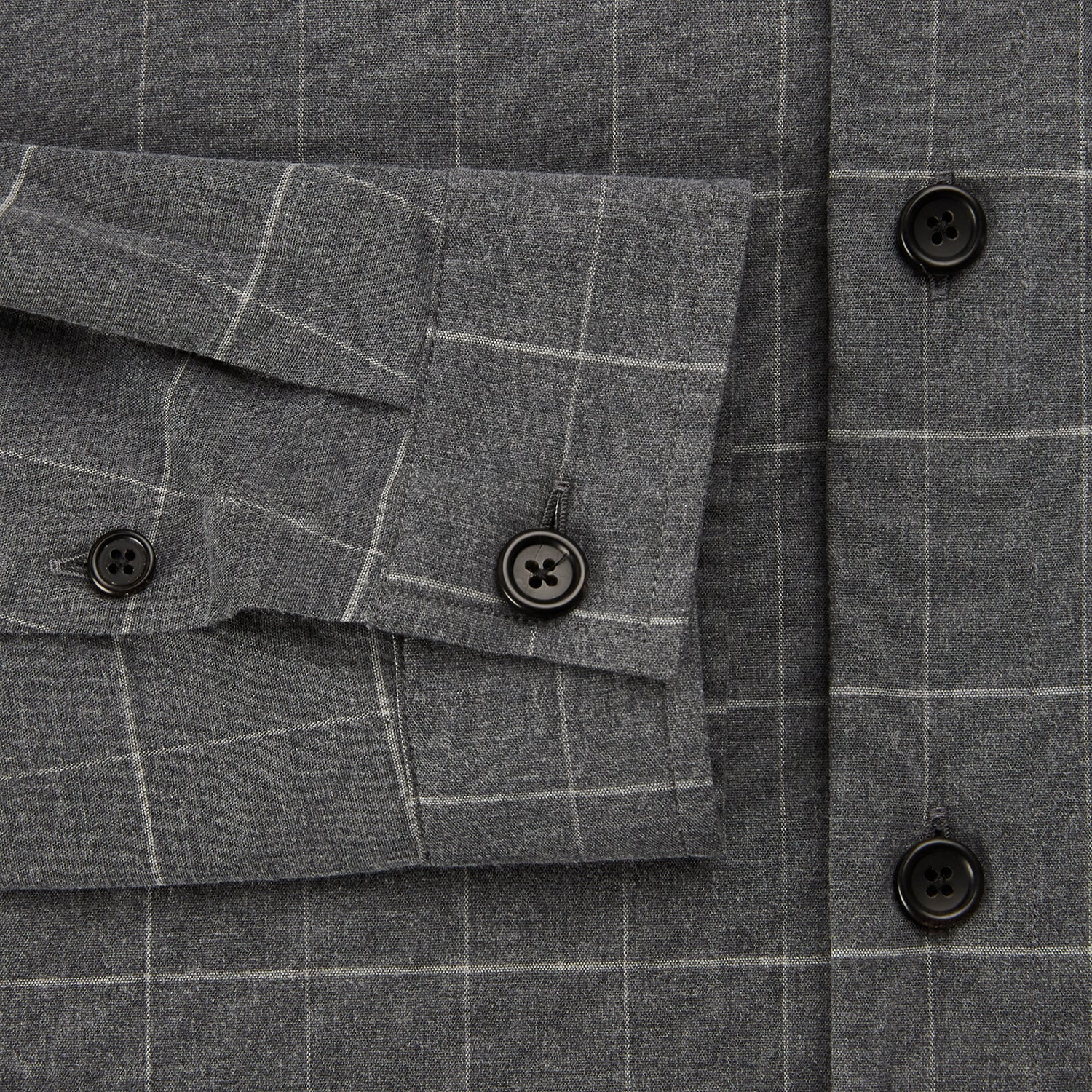 View 4 of product The Turnbull & Asser Charcoal Melange Check Hampstead overshirt, a long-sleeve button-up with a collar and two zippered side pockets, is laid flat on a light gray background.