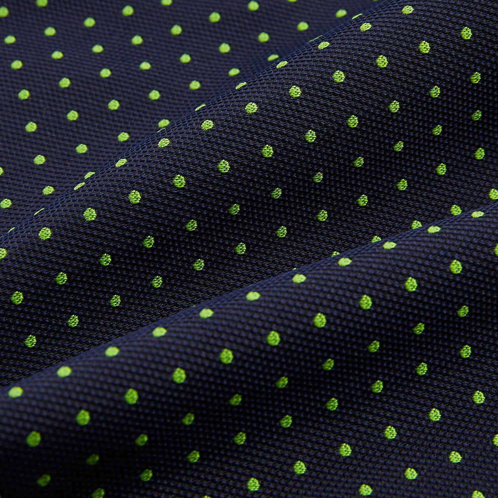 The Green Micro Dot and Navy Silk Cravat by Turnbull & Asser features fine green micro dots on navy silk, adding a refined touch to formalwear. Pair it with a matching pocket square for a cohesive, polished look.