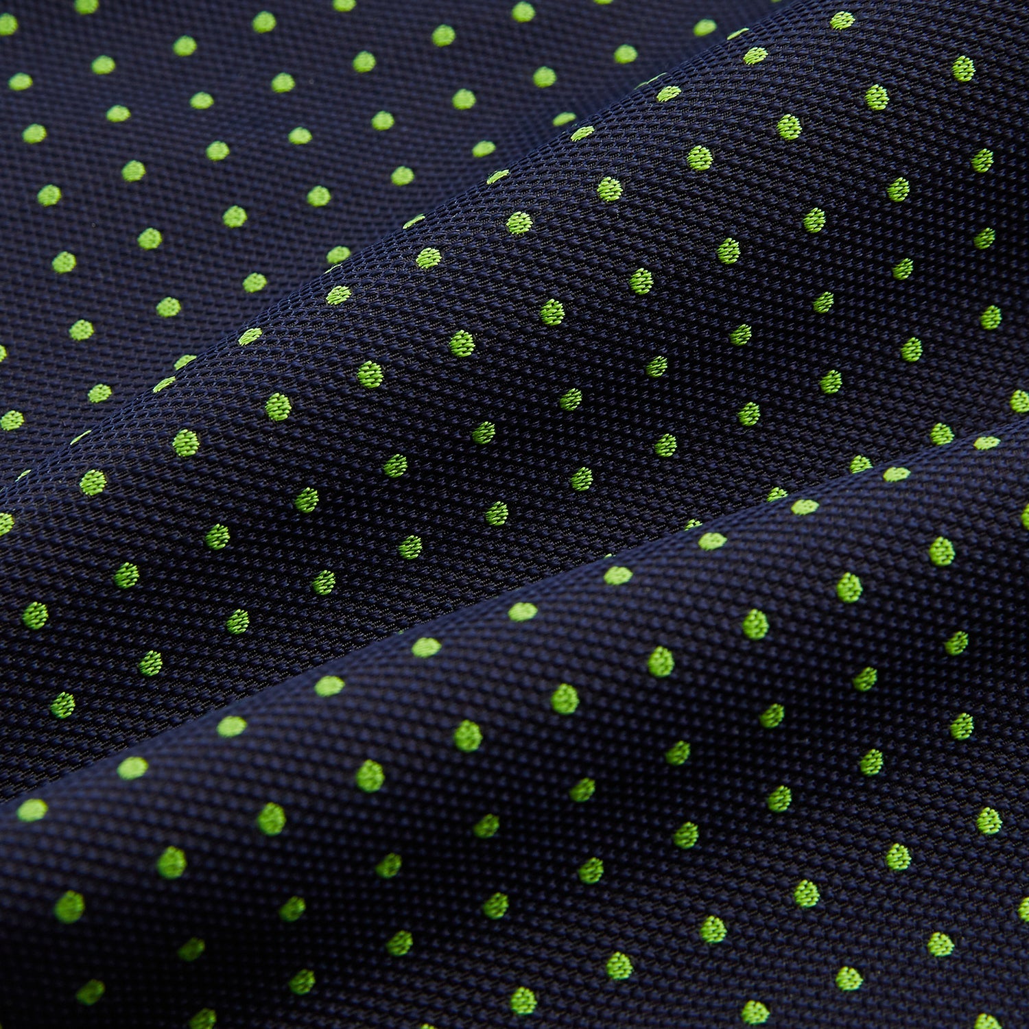 View 4 of product The Green Micro Dot and Navy Silk Cravat by Turnbull & Asser features fine green micro dots on navy silk, adding a refined touch to formalwear. Pair it with a matching pocket square for a cohesive, polished look.