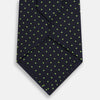 View 3 of product The Turnbull & Asser Green and Navy Micro Dot Silk Tie features small green dots on a navy silk background, displayed rolled up on white.