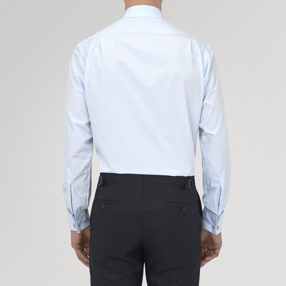 A neatly folded Turnbull & Asser Two-Fold 120 Light Blue Shirt, featuring a regent collar and double cuffs, is displayed against a plain white background.