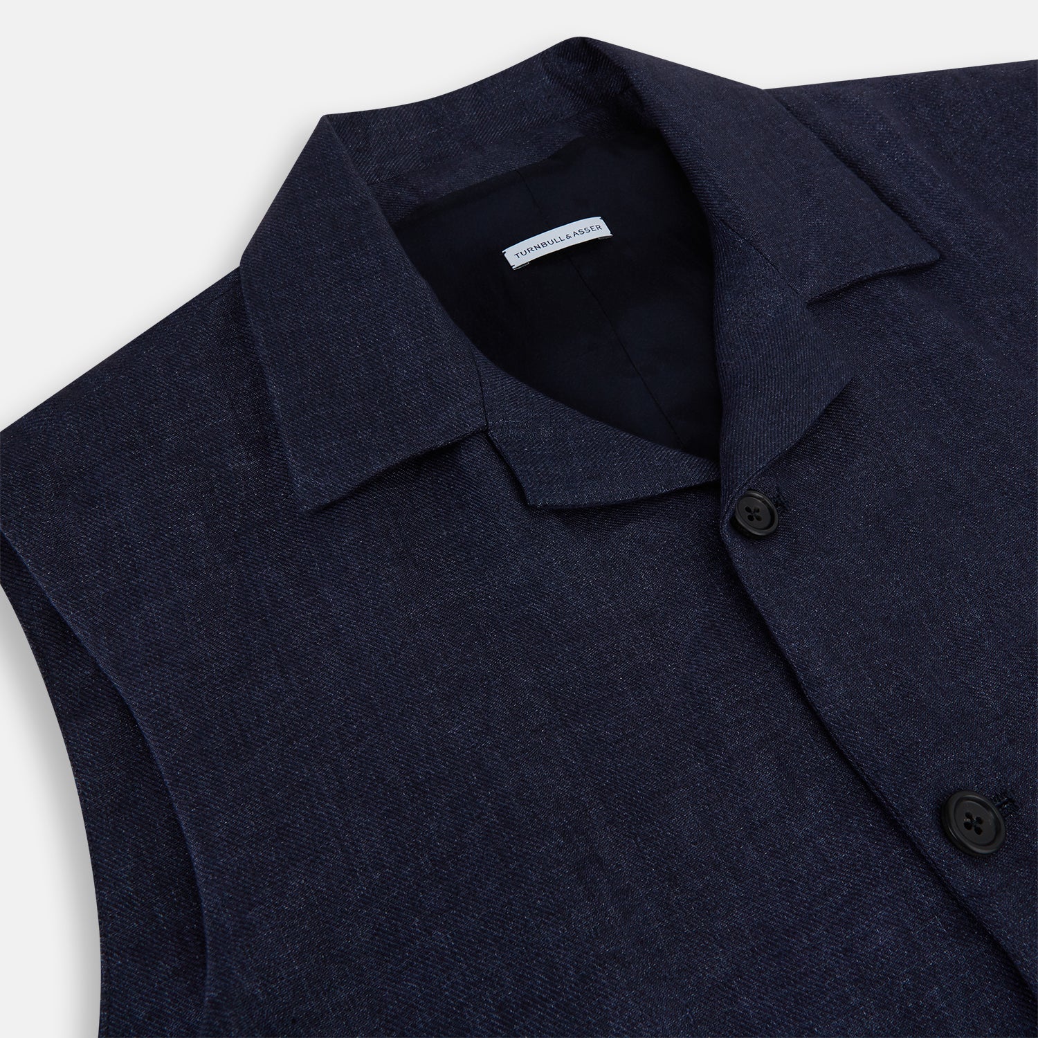 View 2 of product Turnbull & Asser Navy Collared Linen Waistcoat features a tailored fit, sleeveless design, button-up front, left chest pocket, and two zippered side pockets, shown against a plain white background.