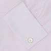 View 6 of product The Turnbull & Asser Pink Herringbone Superfine Cotton Shirt features a T&A collar, double cuffs, and clean-cut design, displayed neatly folded against a white background.