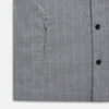 View 7 of product The Turnbull & Asser Grey Check Hampstead Overshirt features a light gray check pattern, pointed collar, chest pocket, and two zippered side pockets, displayed flat against a white background.