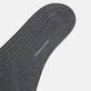 View 4 of product The Turnbull & Asser Steel Melange Mid-Length Sock, in dark gray ribbed mercerised Egyptian cotton, is shown upright on a white background to highlight its elegant shape and texture.