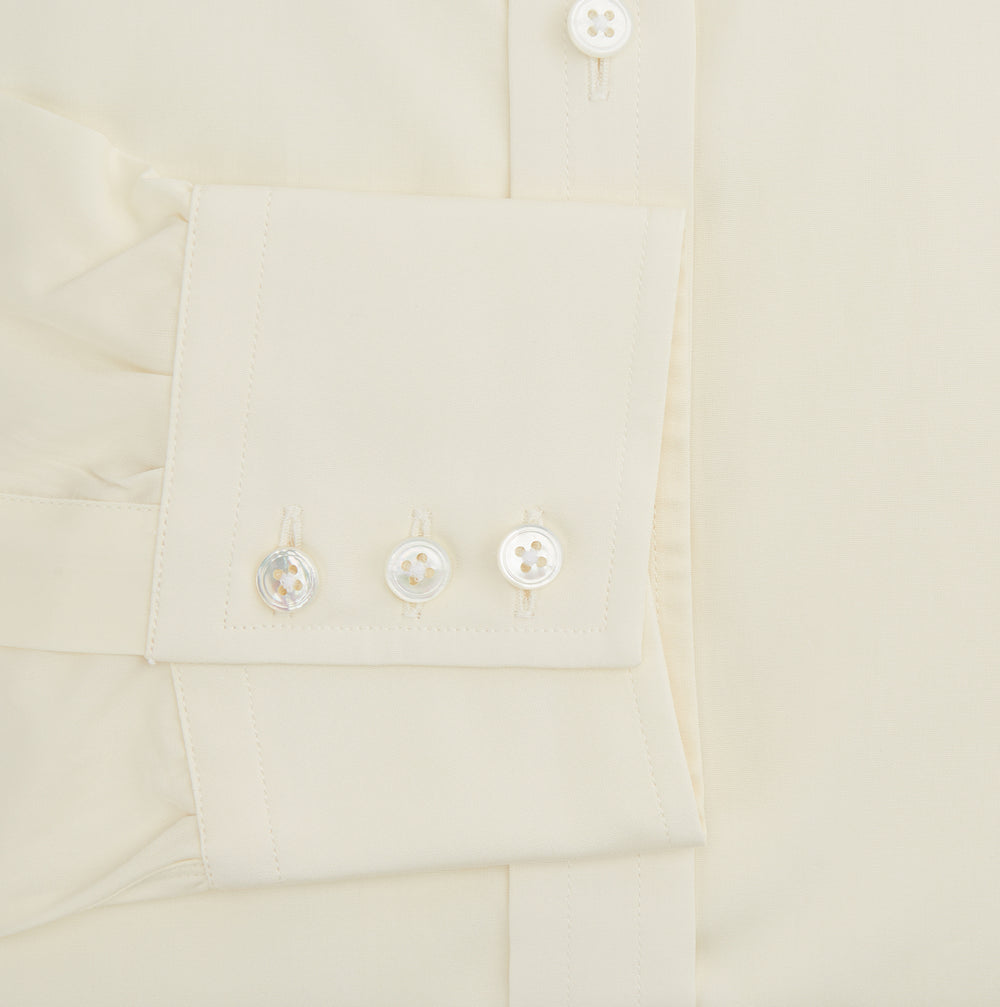 The Cream Cotton Shirt with T&A Collar and 3-Button Cuffs by Turnbull & Asser is ideal for minimalist styles or pairing with bold ties. Shown on a plain white background.