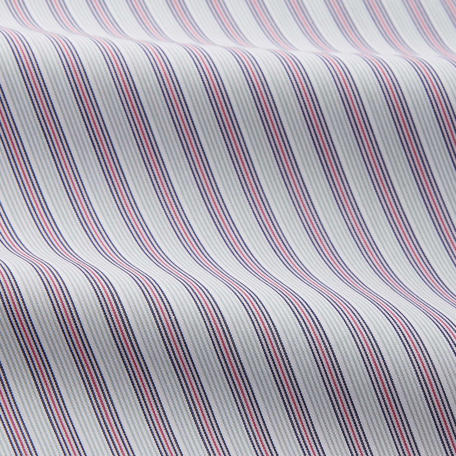 View 2 of product The Turnbull & Asser Red and Blue Multi Stripe Cotton Sussex Nightshirt features long sleeves, a knee-length cut, collared neckline, button placket, chest pocket with dark trim, and rounded hem for luxurious sleepwear.