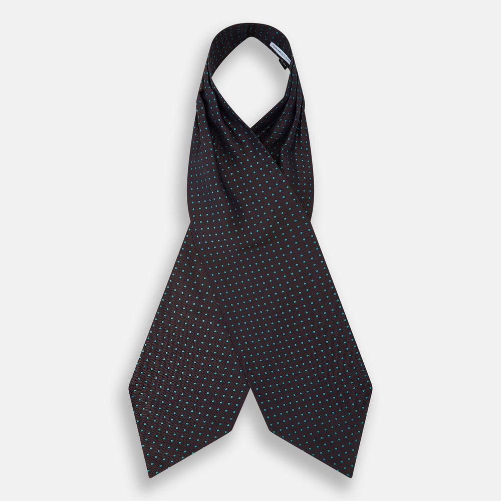 The Turnbull & Asser Blue and Dark Brown Micro Dot Silk Cravat features evenly spaced blue micro dots on dark brown silk, displayed neatly folded on a white background.