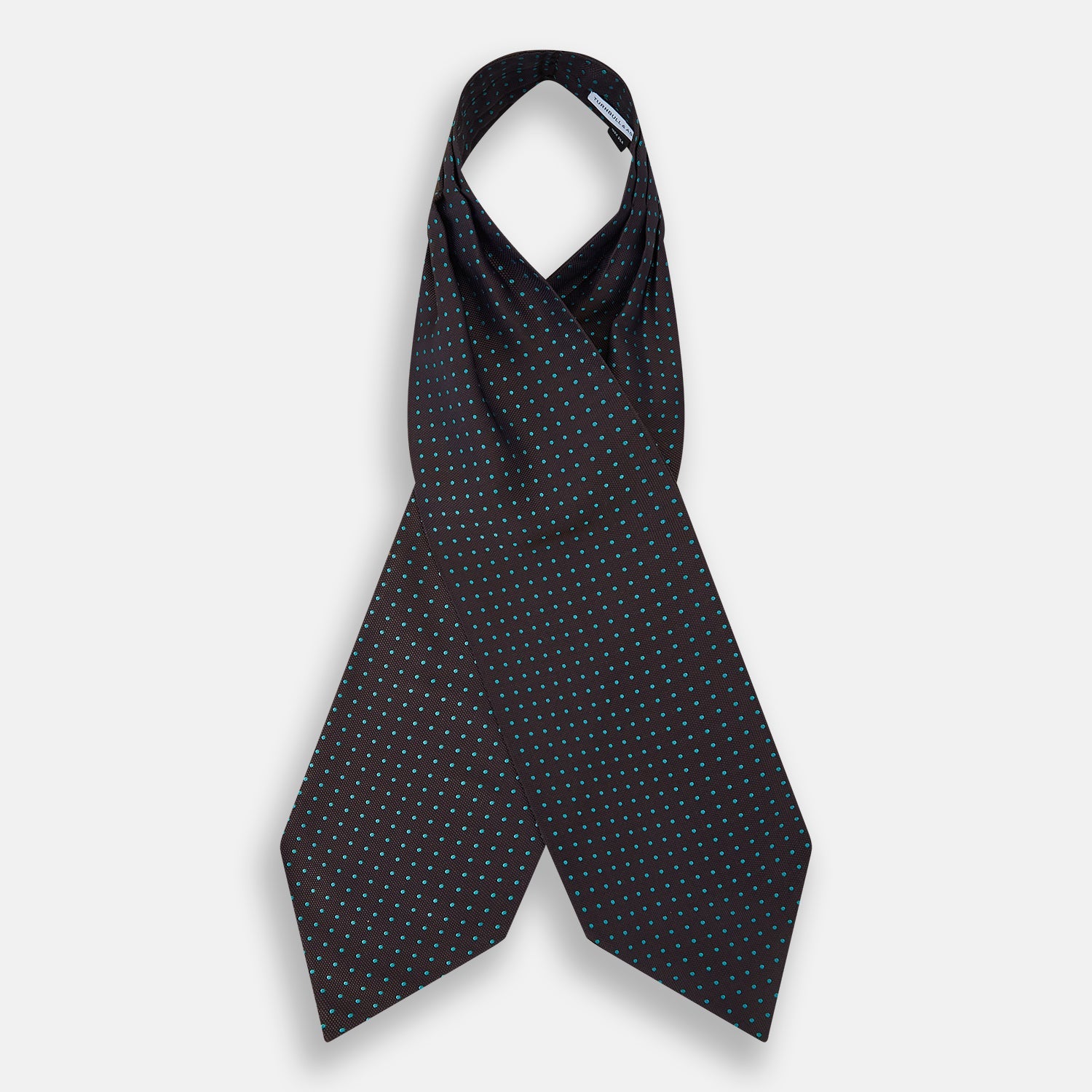 View 2 of product The Turnbull & Asser Blue and Dark Brown Micro Dot Silk Cravat features evenly spaced blue micro dots on dark brown silk, displayed neatly folded on a white background.