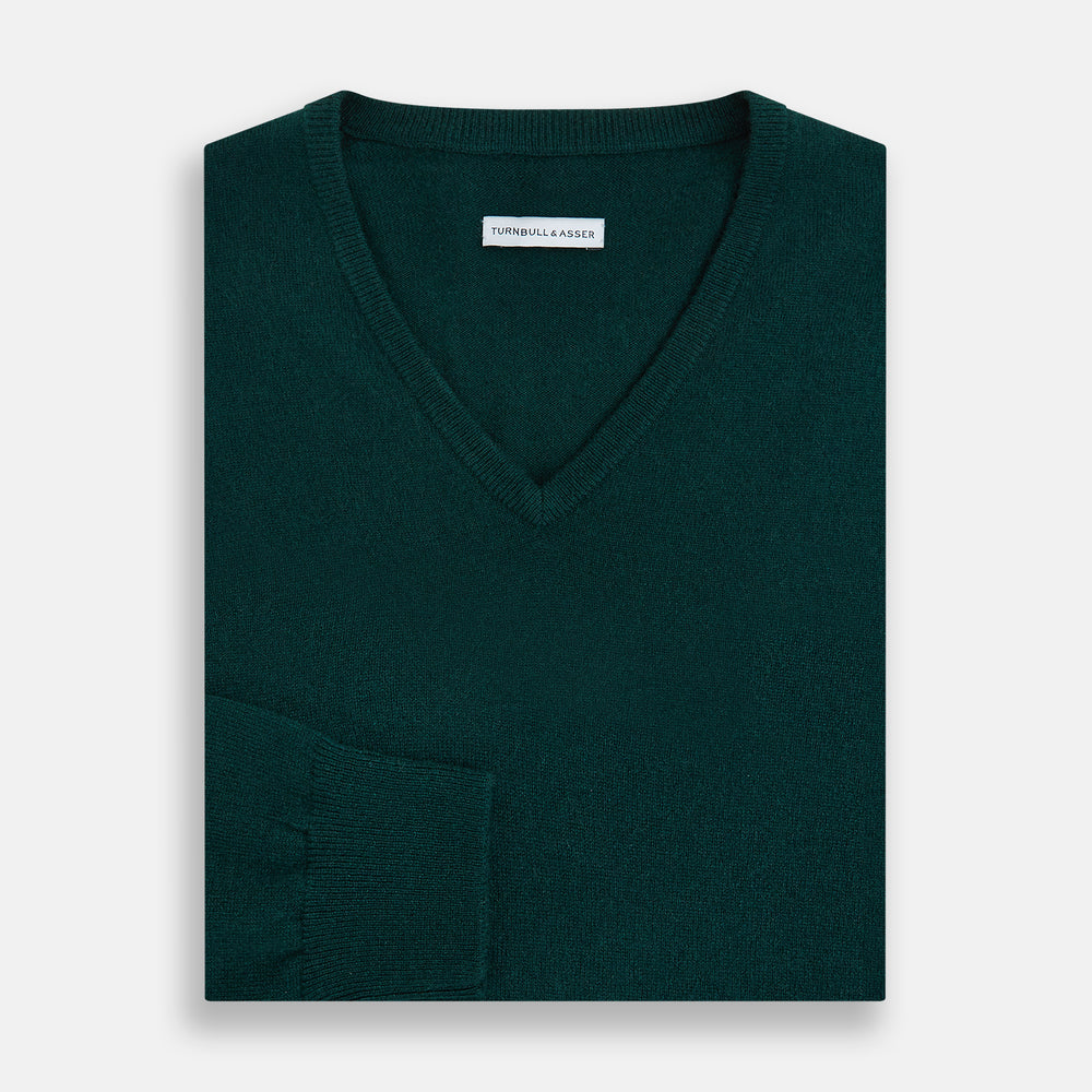 The Turnbull & Asser Forest Green Cashmere V-neck Jumper features ribbed cuffs and hem, shown against a white background—an essential knitwear staple for any wardrobe.