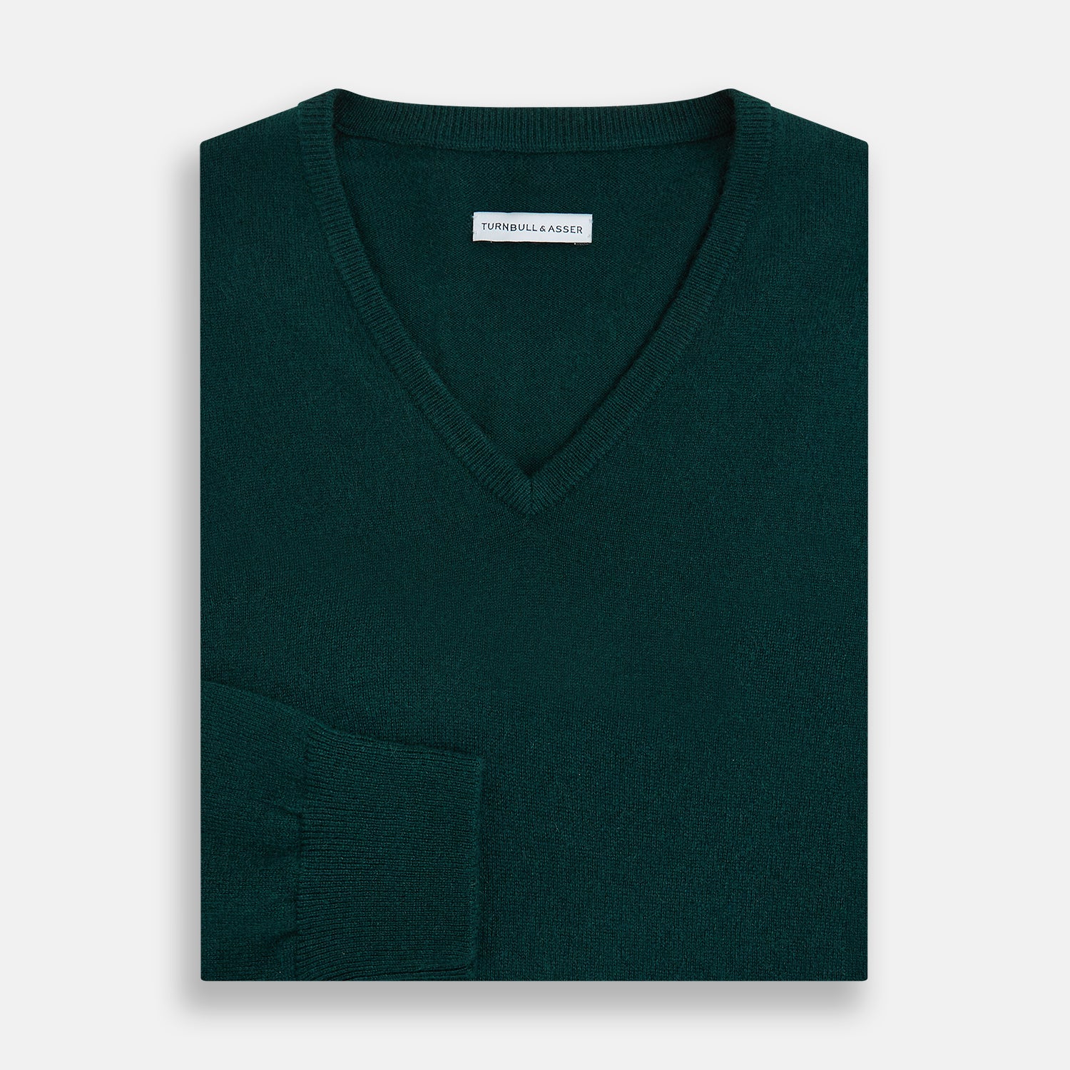 View 4 of product The Turnbull & Asser Forest Green Cashmere V-neck Jumper features ribbed cuffs and hem, shown against a white background—an essential knitwear staple for any wardrobe.