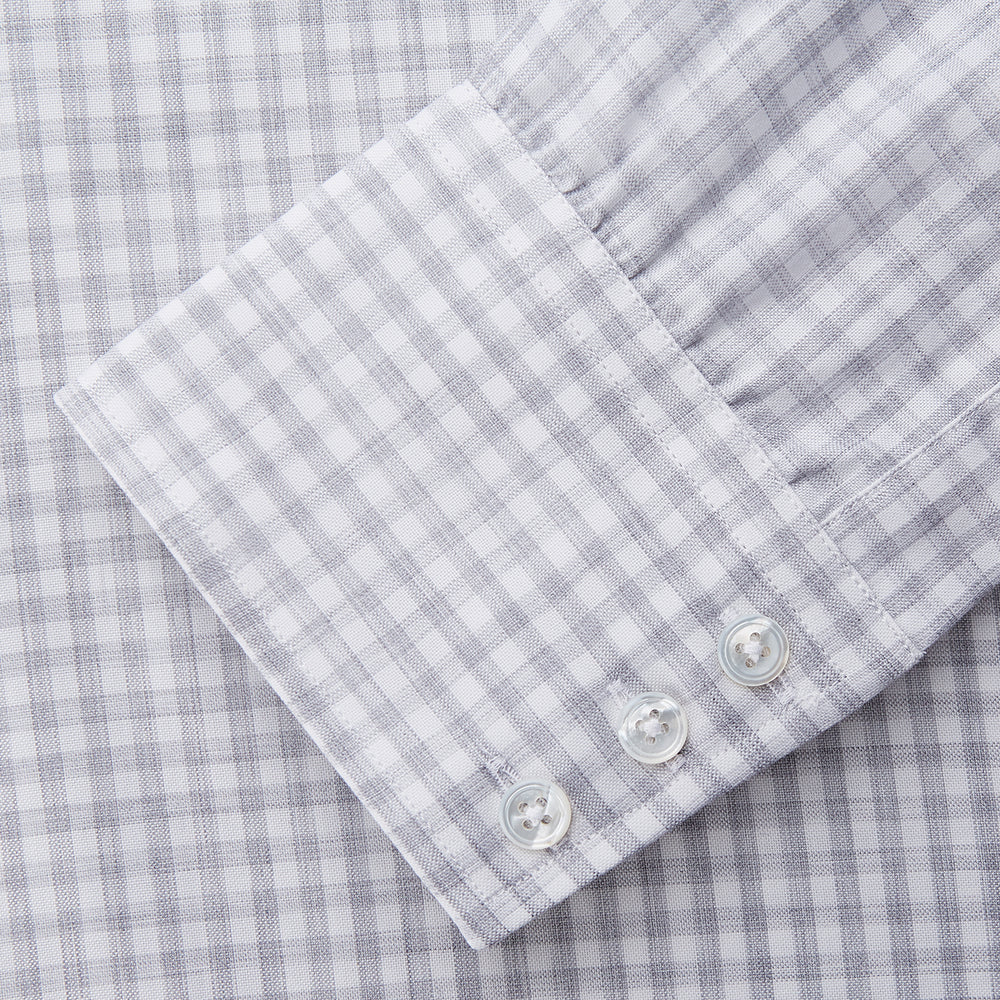 The Grey Check Cotton Melange Regular Fit Mayfair Shirt by Turnbull & Asser features a light gray and white small checkered pattern, a collar, and front buttons, shown against a white background.