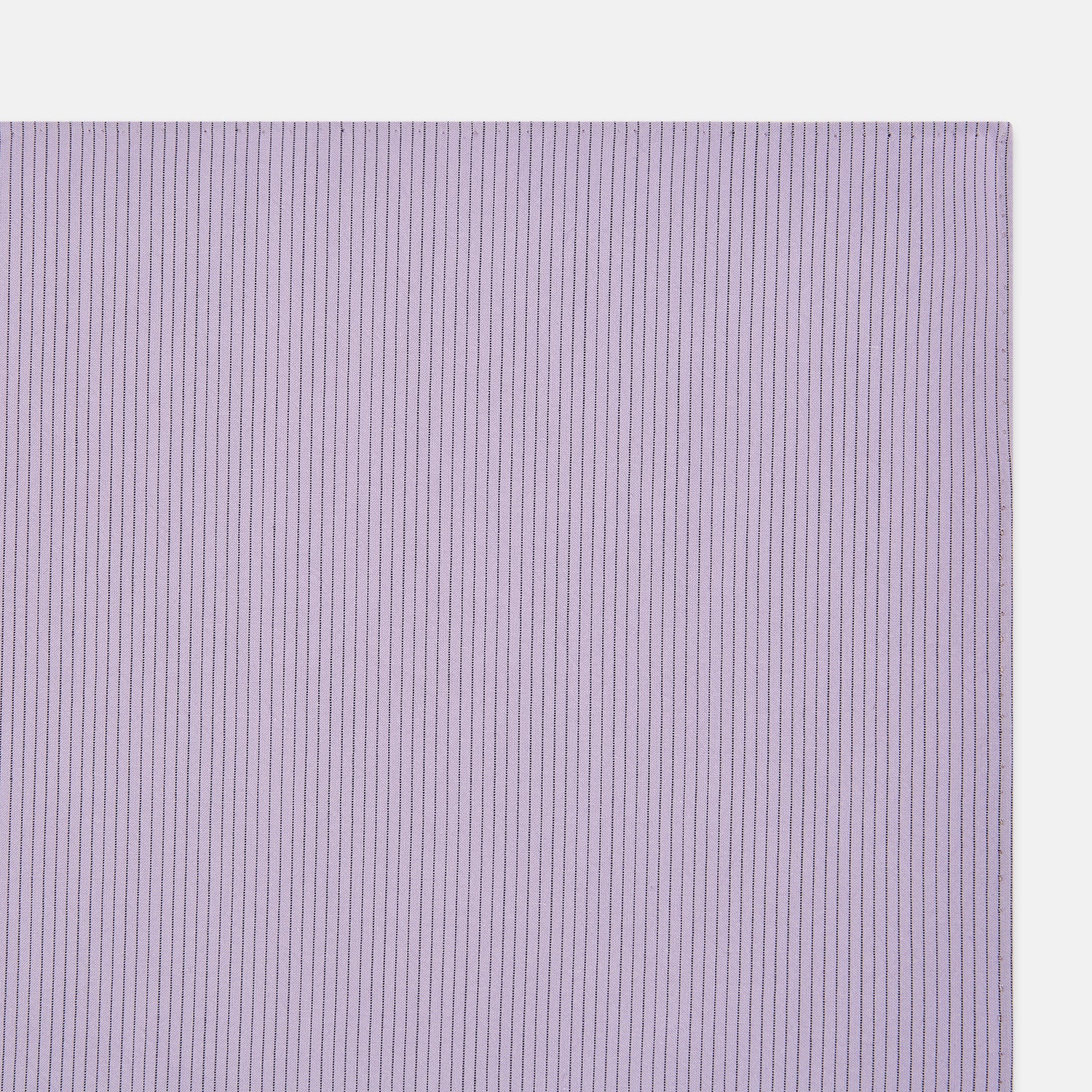 View 2 of product The Turnbull & Asser Lilac Pinstripe Hand-Rolled Handkerchief is a neatly folded, square, lavender piece with a subtle ribbed texture and hand-rolled edges, displayed flat on a white background.