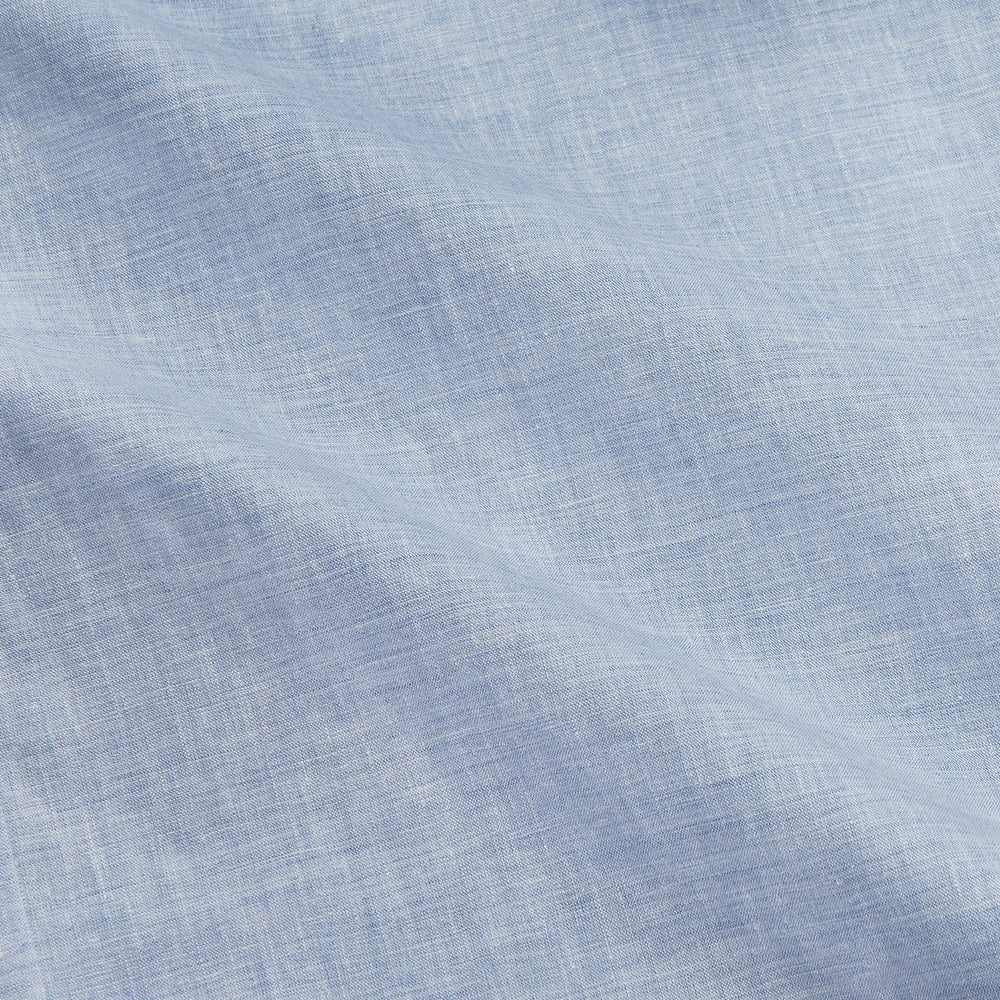 Turnbull & Asser’s Pale Blue Linen Blend Weekend Fit Unwin Shirt features long sleeves, a band collar, two chest pockets, and white buttons—ideal for casual summer wear.