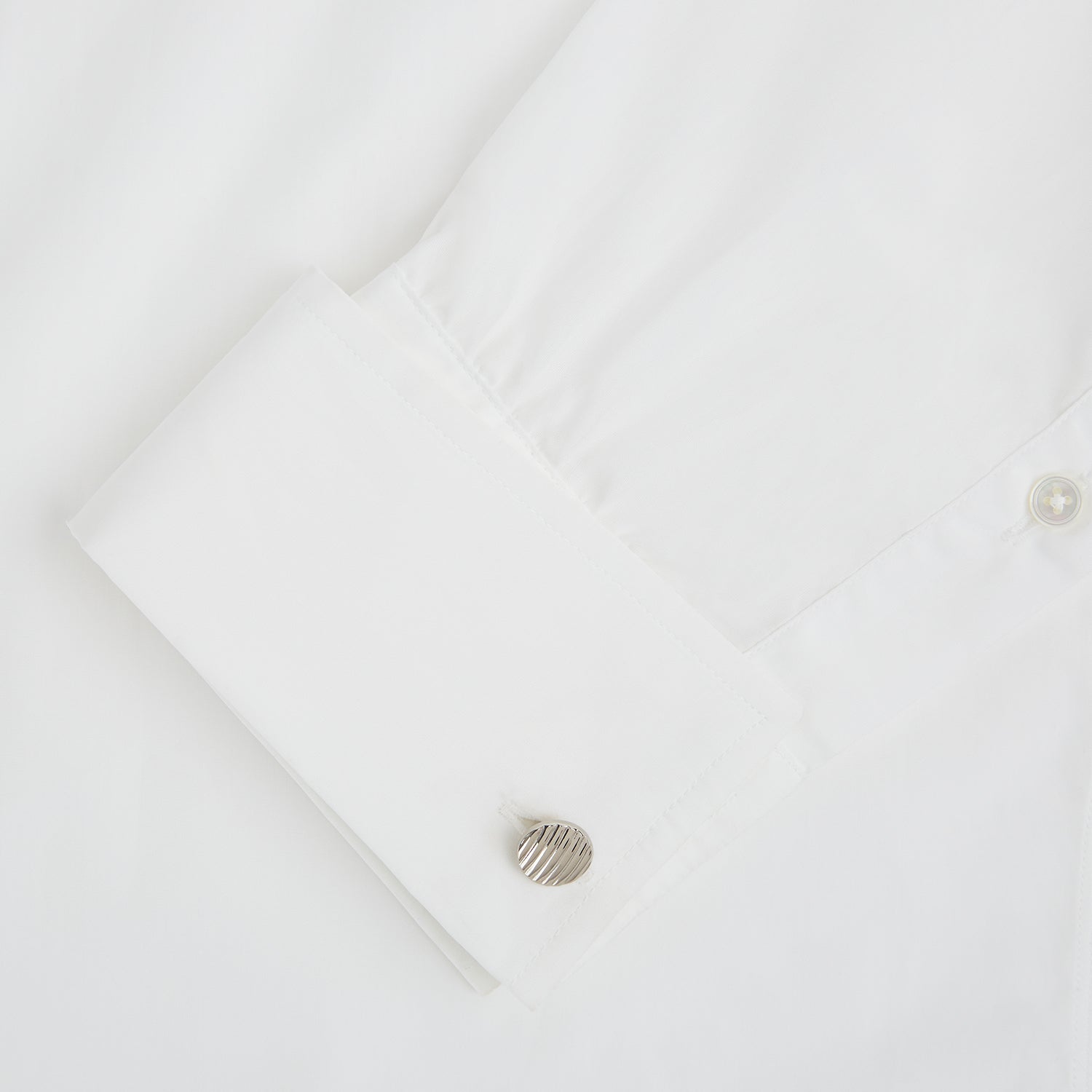 View 3 of product Turnbull & Asser’s Silver Striped Circle Cufflinks feature classic diagonal grooves and are shown against a white background.