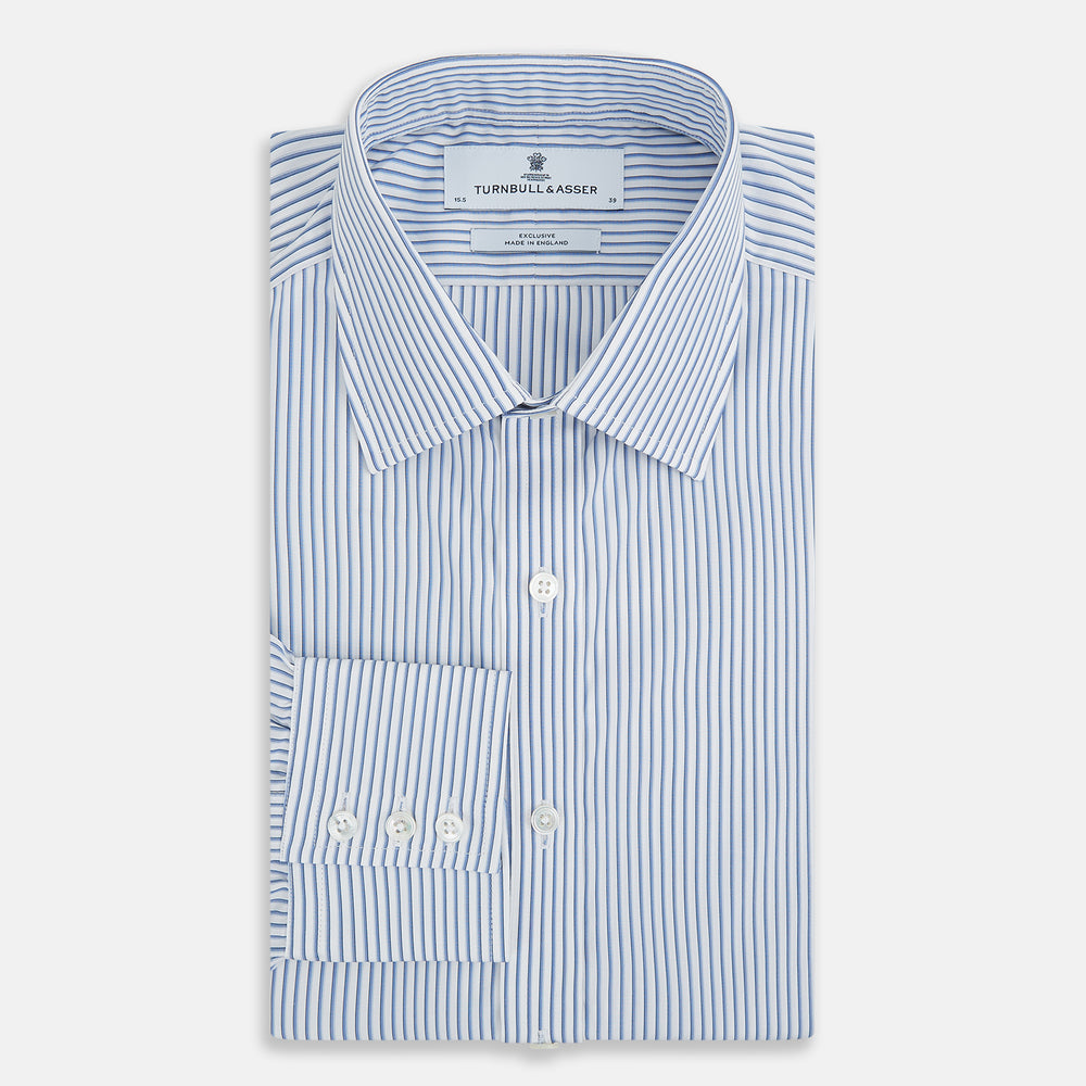 The Turnbull & Asser Blue Shadow Stripe Mayfair Shirt is a long-sleeve button-up with a T&A collar and thin blue vertical stripes on white, shown on a plain white background.
