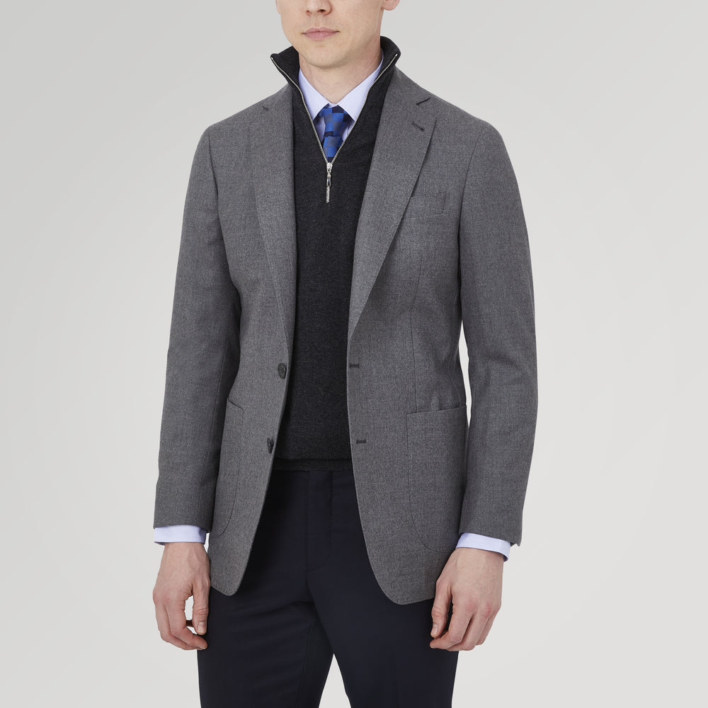 The Turnbull & Asser Grey Merino Wool Jacket is single-breasted with a notched lapel, two front patch pockets, and a single button closure, fashioned from fine Super Merino Wool. Shown here against a plain white background.