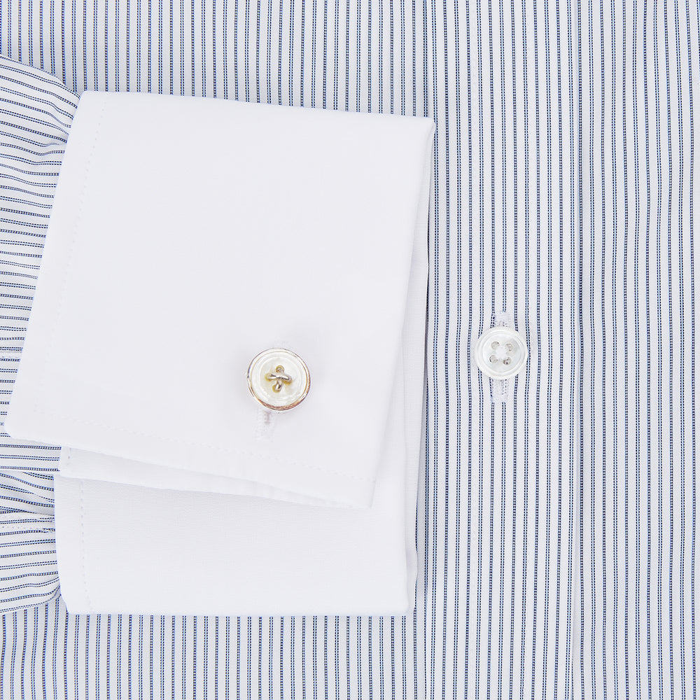 The Turnbull & Asser Navy and Blue Ticking Stripe Shirt features a contrast white collar and double cuffs, displayed on a plain white background. Tailored in the sleek Mayfair fit, it’s ideal for formal attire.