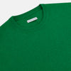 View 9 of product The Turnbull & Asser Grass Green Cashmere Round Neck Jumper features long sleeves, ribbed cuffs, collar, and hem, shown on a white background.