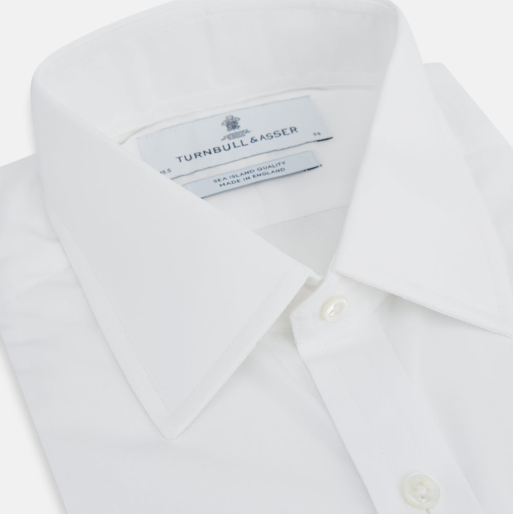 The Turnbull & Asser White Sea Island Quality Cotton Shirt features a T&A collar and 3-button cuffs, crafted from premium cotton and showcased against a plain white background.