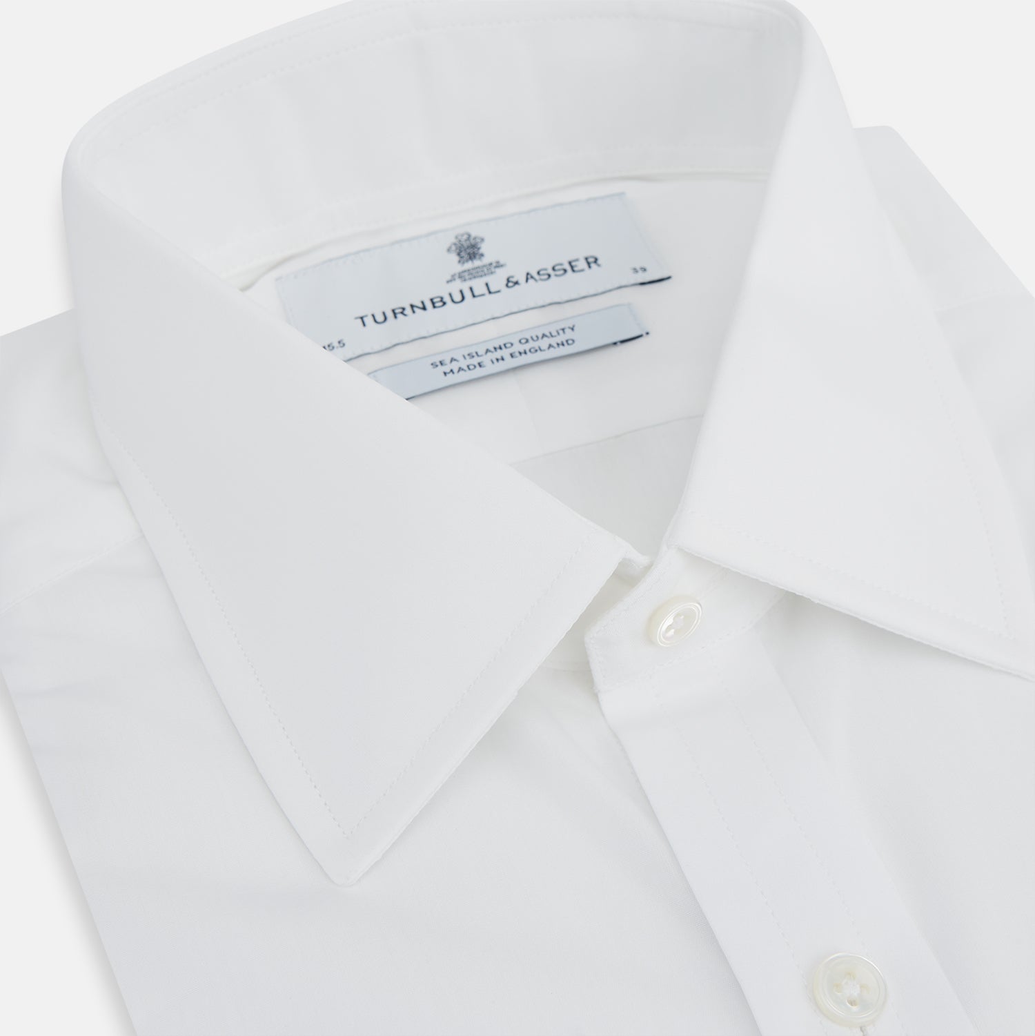 View 2 of product The Turnbull & Asser White Sea Island Quality Cotton Shirt features a T&A collar and 3-button cuffs, crafted from premium cotton and showcased against a plain white background.