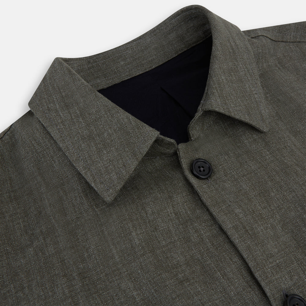The Olive Linen Holland Shacket by Turnbull & Asser is a lightweight olive button-up jacket in Irish linen with a collar, two front pockets, one chest pocket, and slanted hem pockets—ideal outerwear shown on a plain white background.