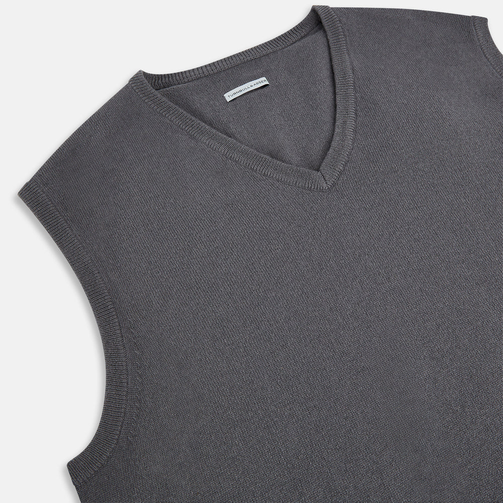 The Turnbull & Asser Slate Grey V-neck Cashmere Vest, shown against a white background, is a sophisticated sleeveless jumper ideal for refined ensembles.