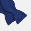 View 3 of product The HOUNDSTOOTH NAVY CRUISE BOW TIE by Turnbull & Asser features a refined textured pattern in blue, neatly tied and set against a white background—a stylish, versatile accessory for the modern gentleman.