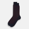 View 2 of product A single Navy/Red Motif Mid-Length Sock by Turnbull & Asser, displayed upright on a white background. The sock features a calf-length style, ribbed cuff, hand-linked toe for comfort, and a subtle red pattern.