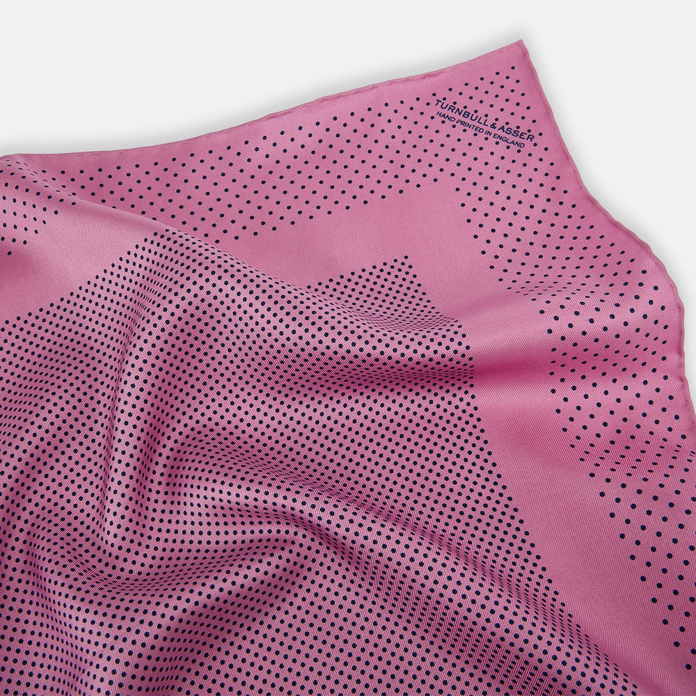 The Pink Dot Silk Pocket Square by Turnbull & Asser features pink silk with a border of small black dots, expertly handcrafted for a stylish touch to any suit. Fold to showcase both sides for added elegance.