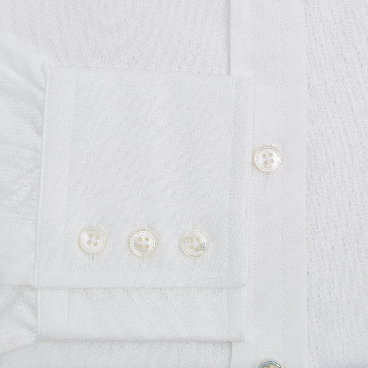 View 4 of product The Turnbull & Asser White Herringbone Mayfair Shirt features long sleeves and a classic collar—a timeless wardrobe essential, shown here against a white background.