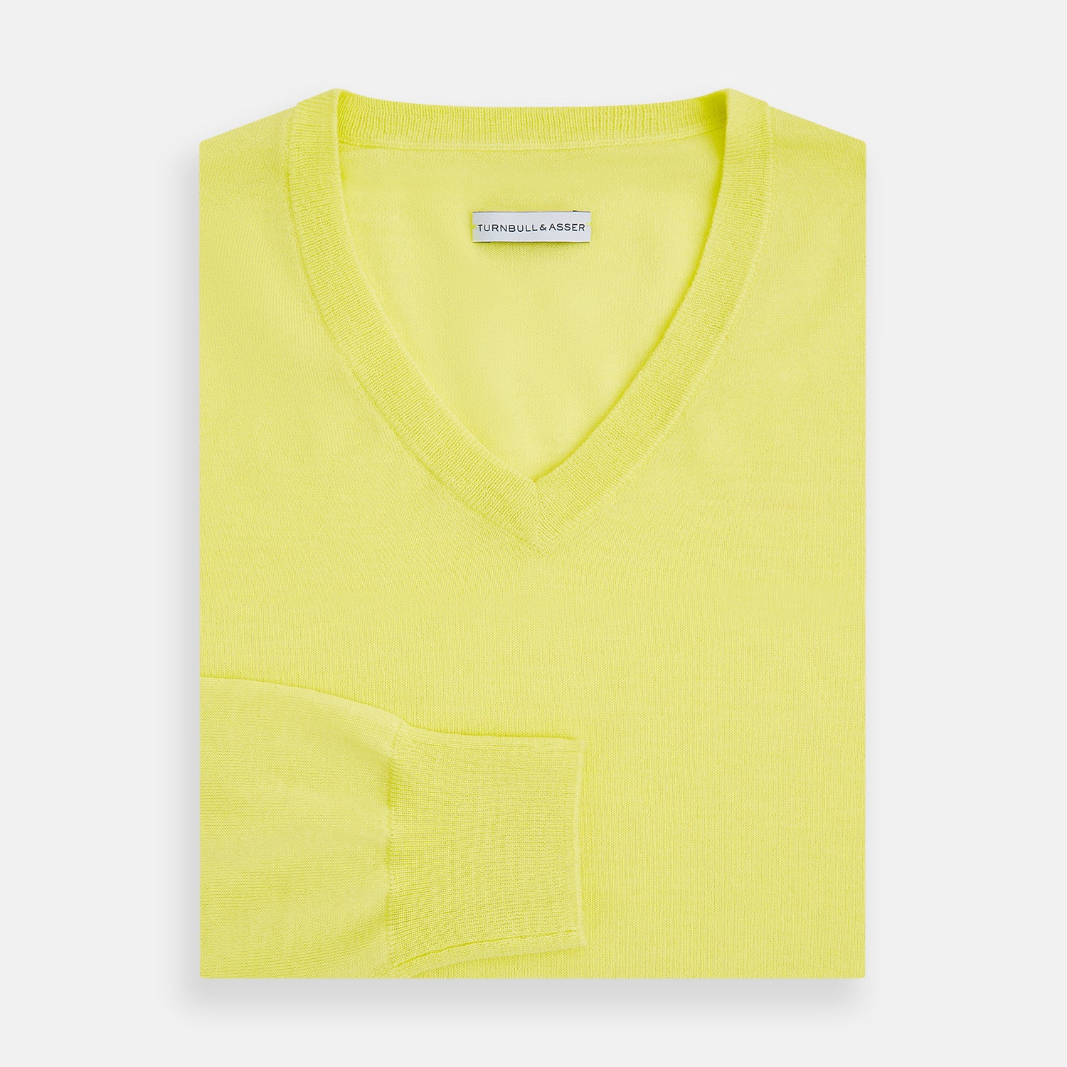 View 4 of product The Turnbull & Asser Bright Yellow Cashmere V-neck Jumper, a plain long-sleeved knitwear sweater, is showcased against a white background.