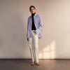 View 11 of product The Turnbull & Asser Pale Blue Candy Stripe Cotton Marlene Shirt is an oversized women's collared shirt with long sleeves, buttoned cuffs, and vertical blue and white stripes, shown laid flat on a white background.