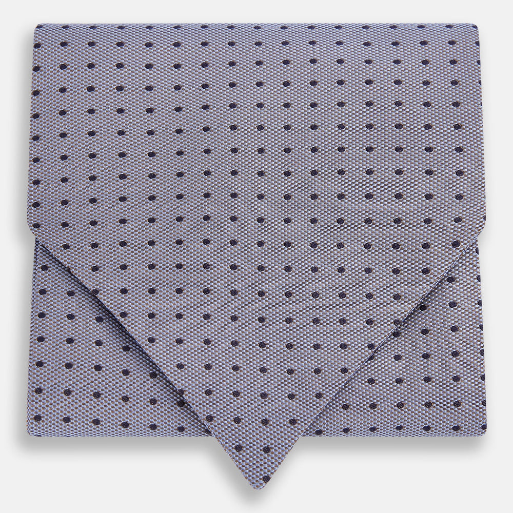 A light gray pocket square with small black polka dots pairs perfectly with the Turnbull & Asser Navy and Light Blue Micro Dot Silk Cravat for a refined, polished formal look.