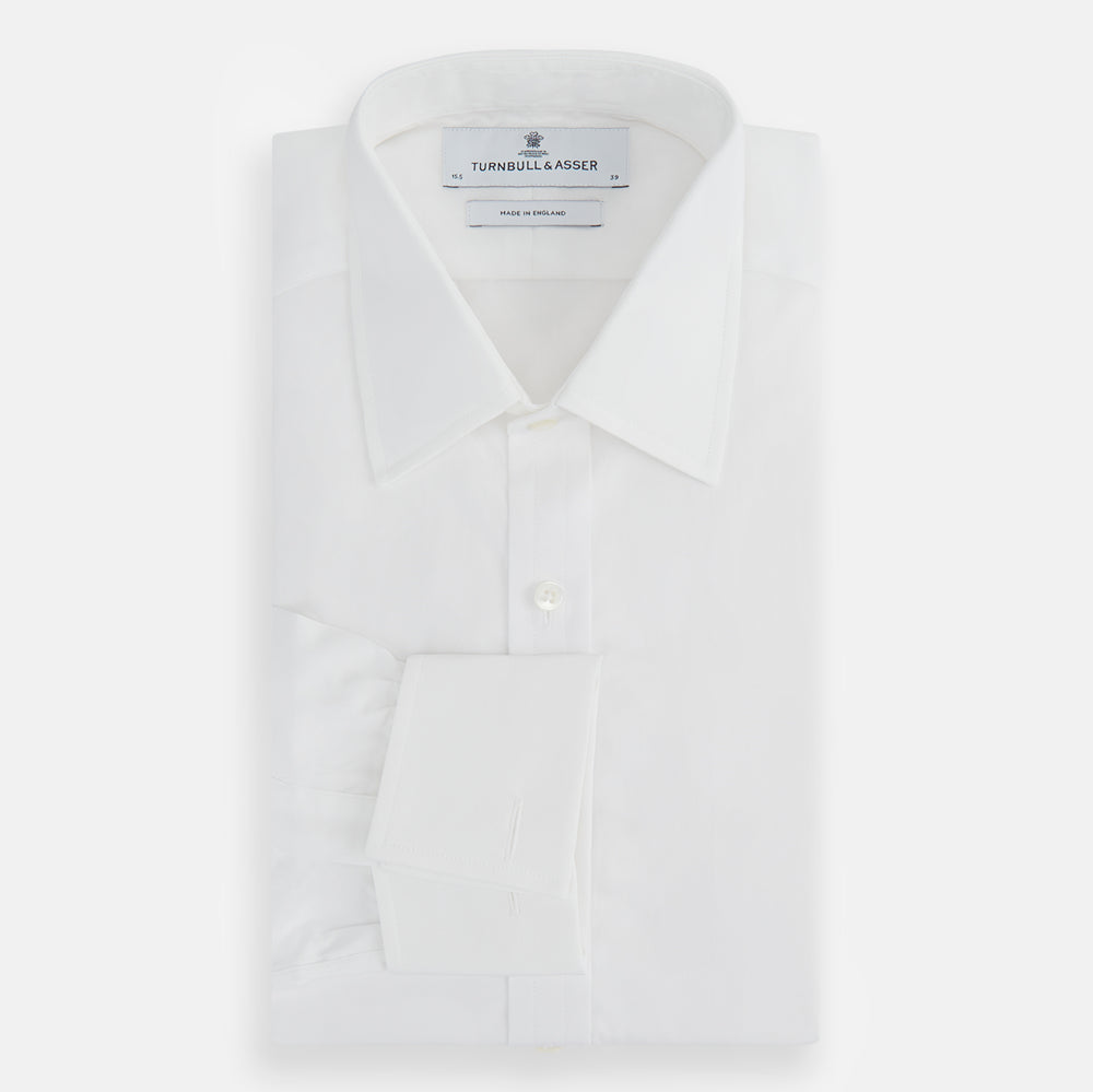 The Turnbull & Asser Plain White Cotton Shirt features a T&A collar and double cuffs, shown flat on a white background—ideal for pairing with standout ties or achieving a minimalist look.