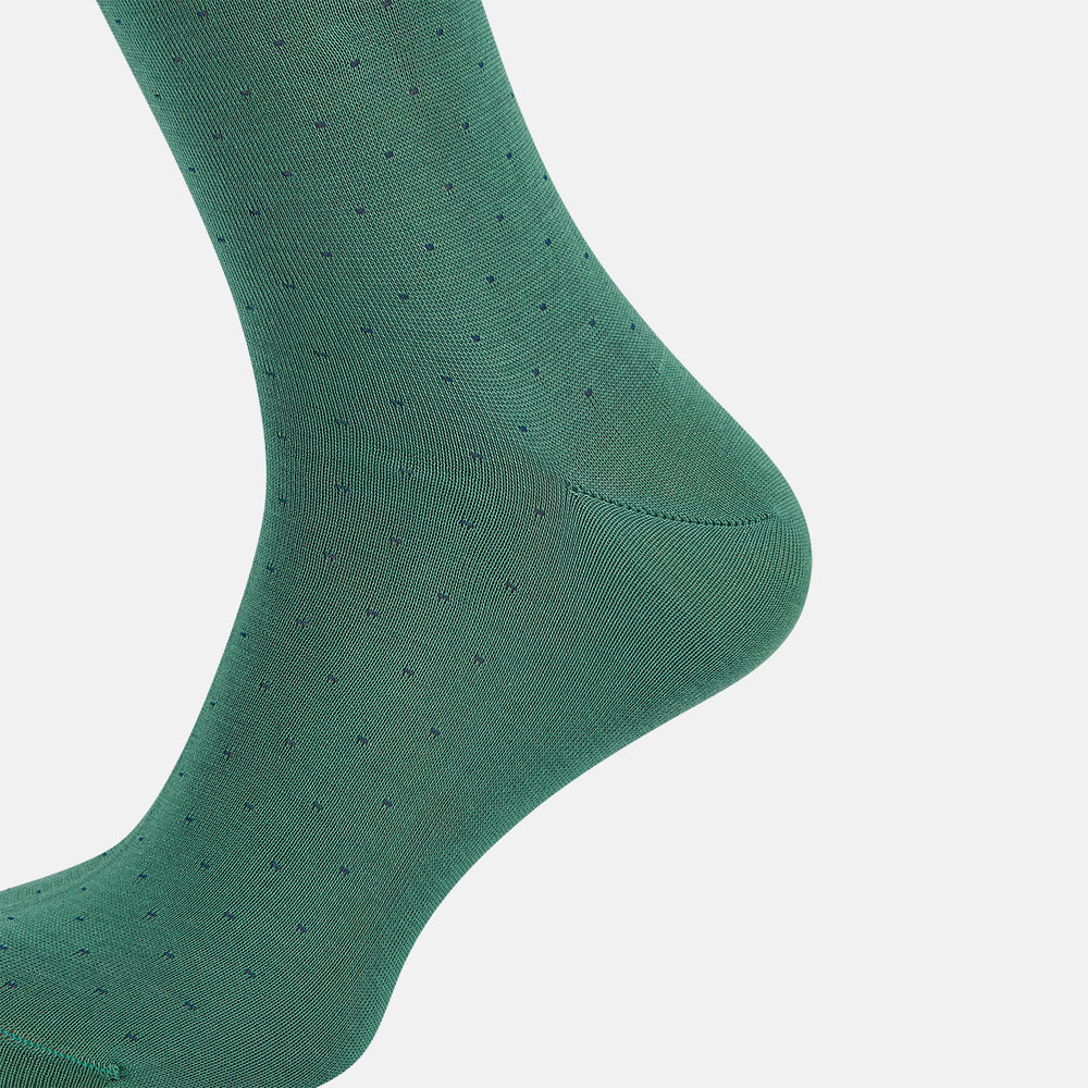 The Turnbull & Asser Forest Green/Navy Dot Mid-Length Sock is shown upright with the foot pointed right against a white background, highlighting its subtle polka dot pattern.