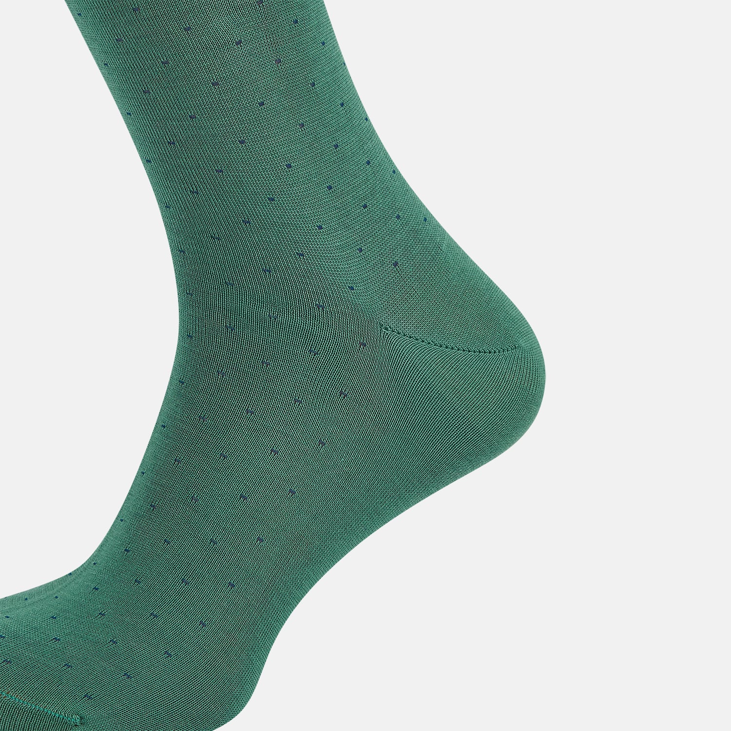 View 4 of product The Turnbull & Asser Forest Green/Navy Dot Mid-Length Sock is shown upright with the foot pointed right against a white background, highlighting its subtle polka dot pattern.