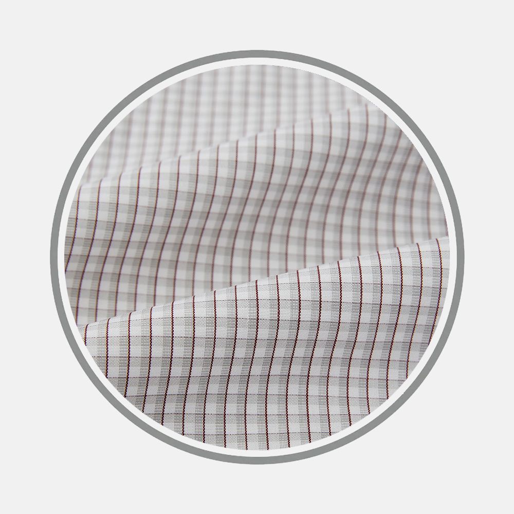 Close-up of Turnbull & Asser's Grey Micro Shadow Fabric, featuring a soft texture and a subtle grid of thin, evenly spaced grey lines. The material is gently folded within a circular frame set against a light background.